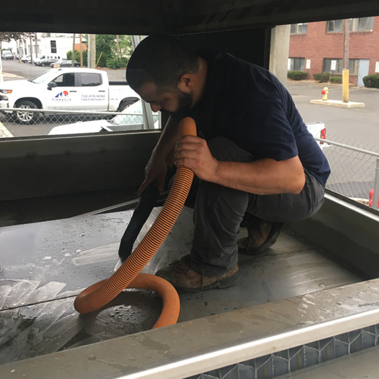 vacuuming-debris-from-lower-sump-of-an-evapco-lste-cooling-tower