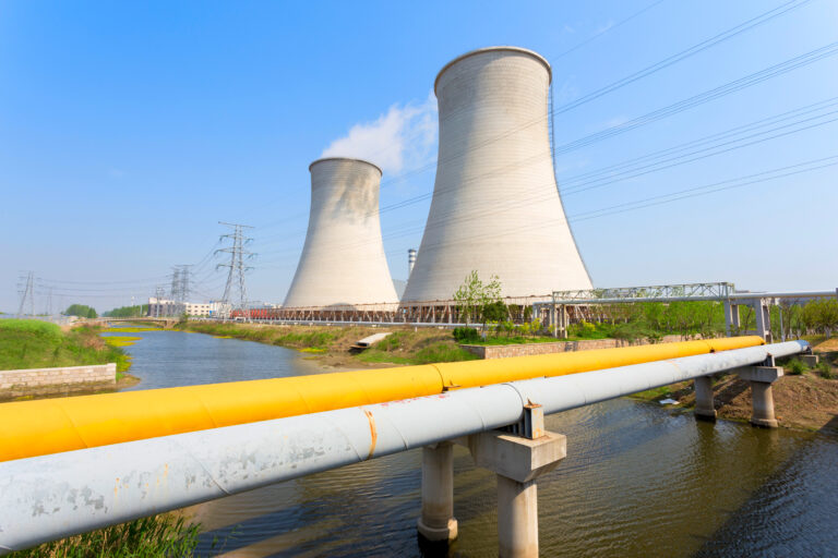 coal fired power station with cooling towers releasing steam int